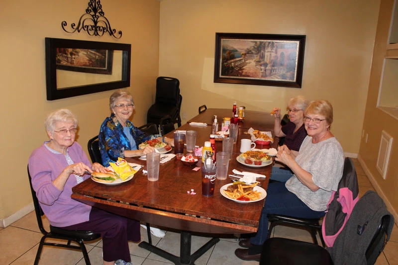 A Piper 55 and Alive fellowship group sharing a meal around a table.
